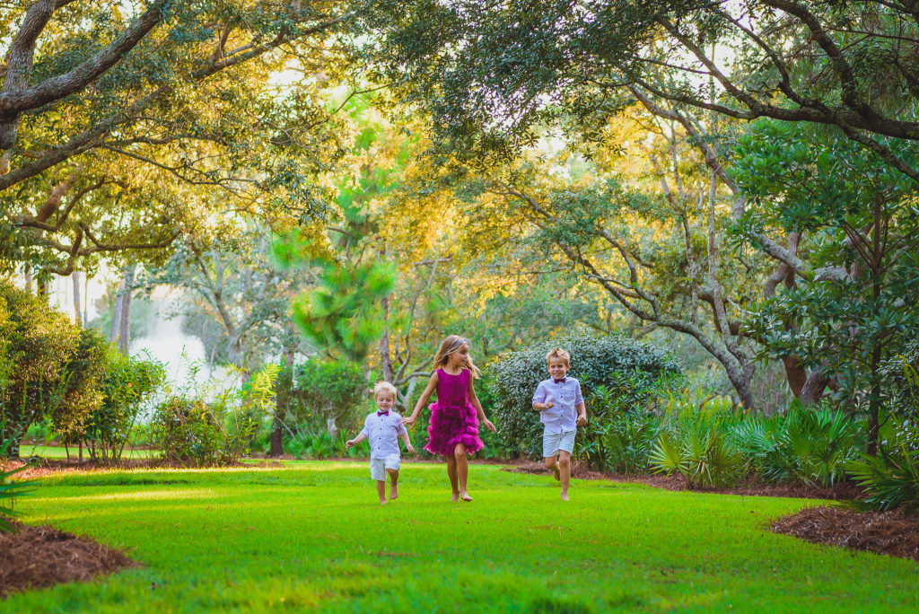 kids running barefoot on the grass in beautiful Sarasota park