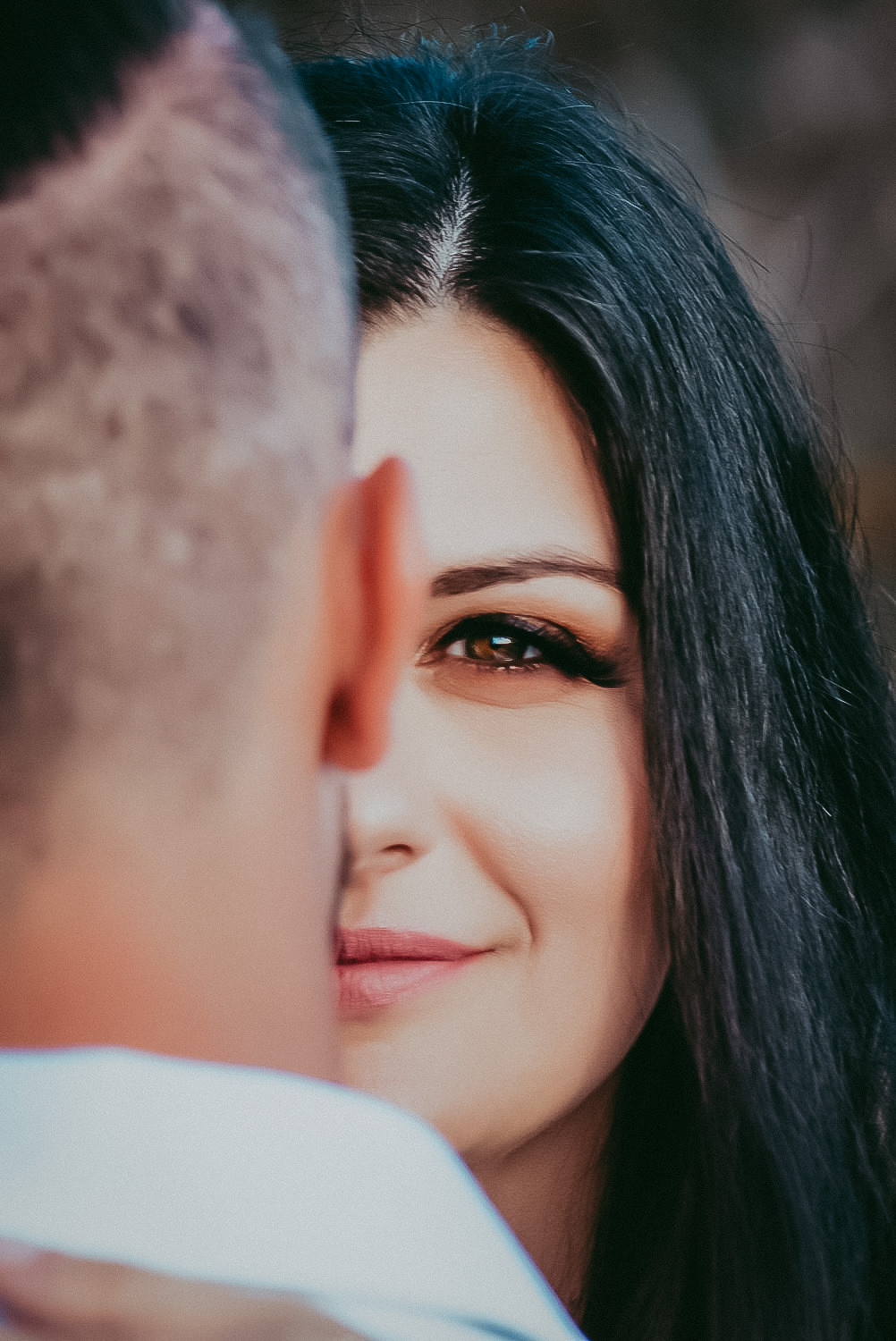 closeup of the bride face covered in half by grooms head