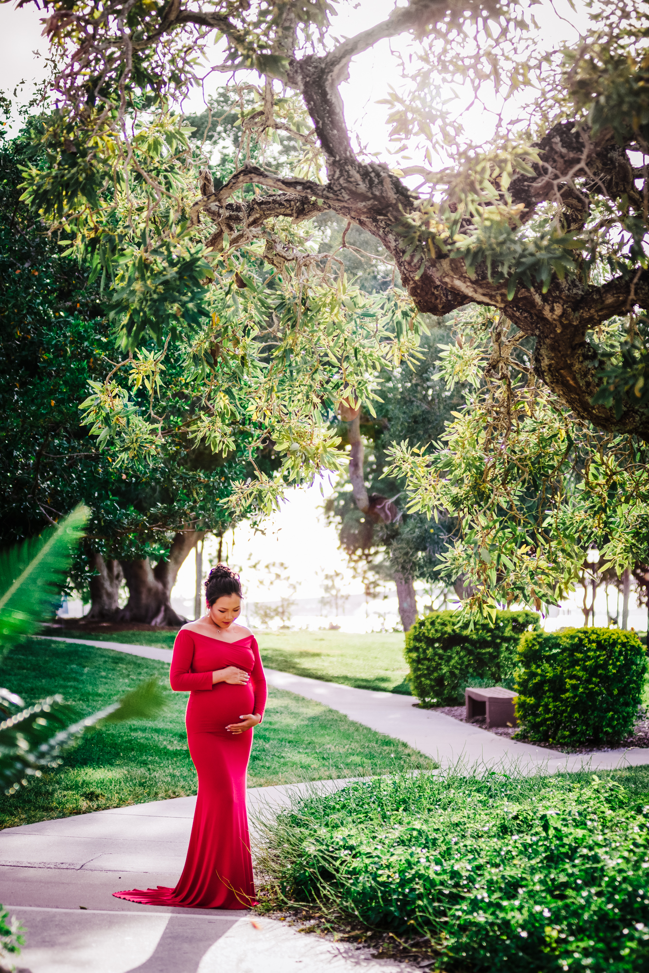 Maternity portrait of gorgeous pregnant women in the red long dress at Marina Jack Park in Sarasota,Fl 