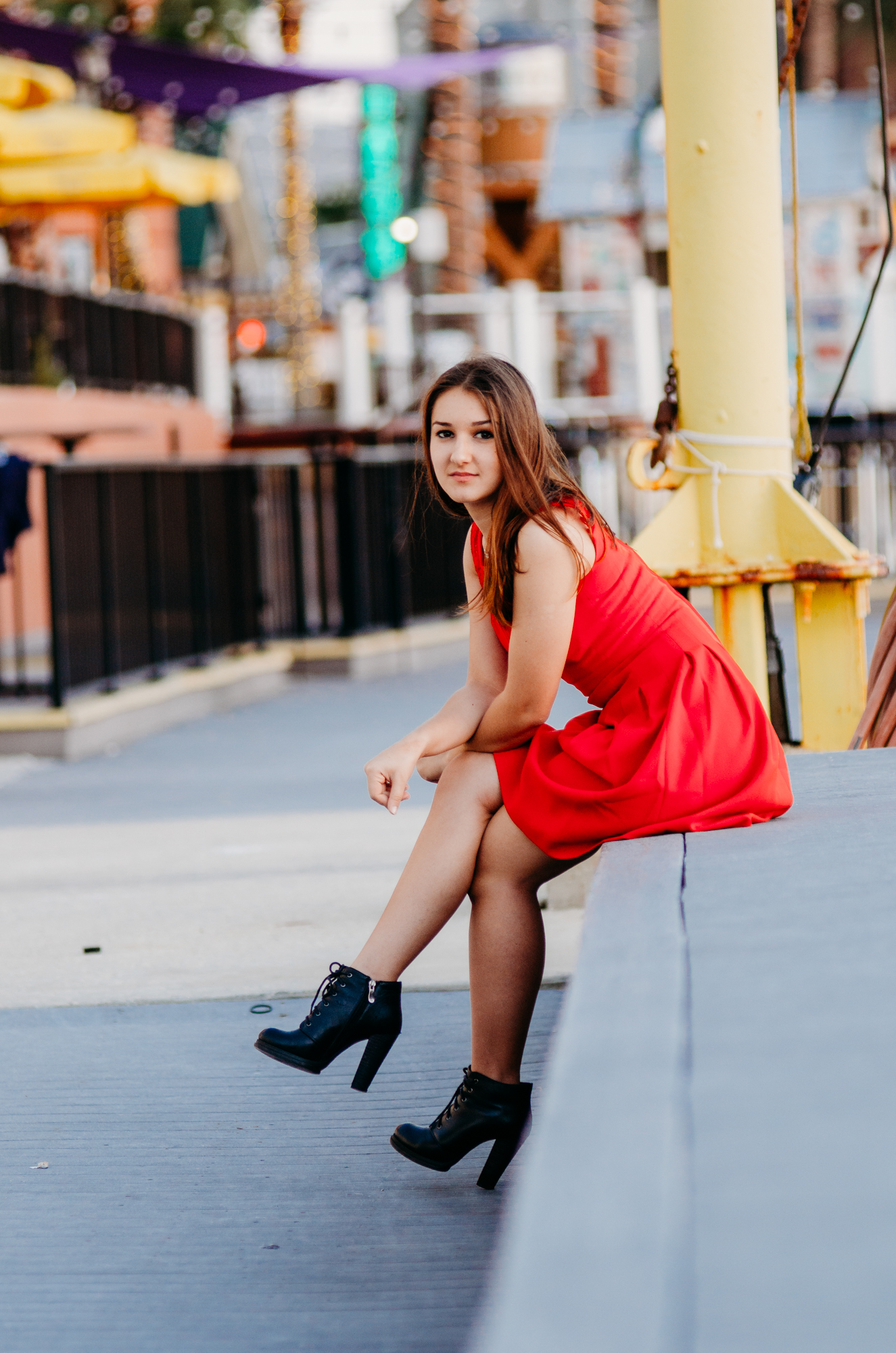 High school girl in red dress posing in the Bayfront Marina