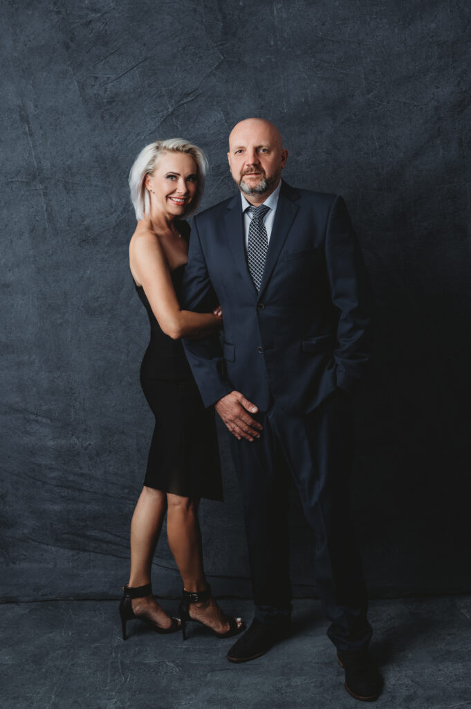 A couple posing for a portrait at a portrait studio.