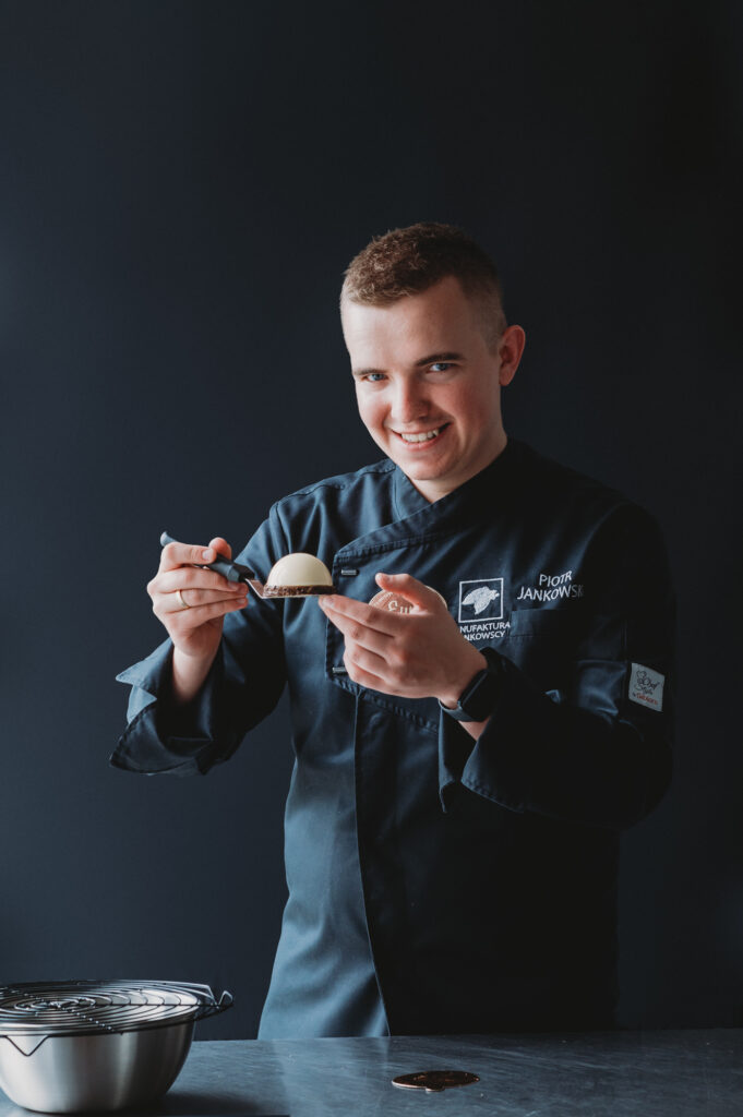 A business portrait of a professional chef holding a desert