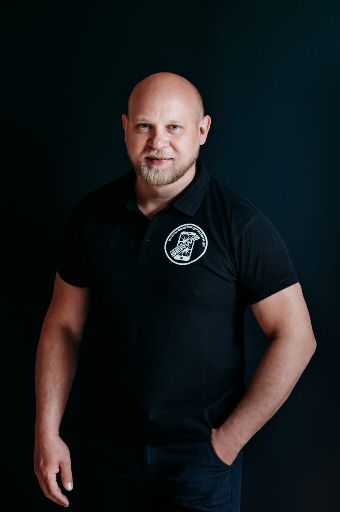 Headshot of Mobile services team boss  wearing company logo shirt