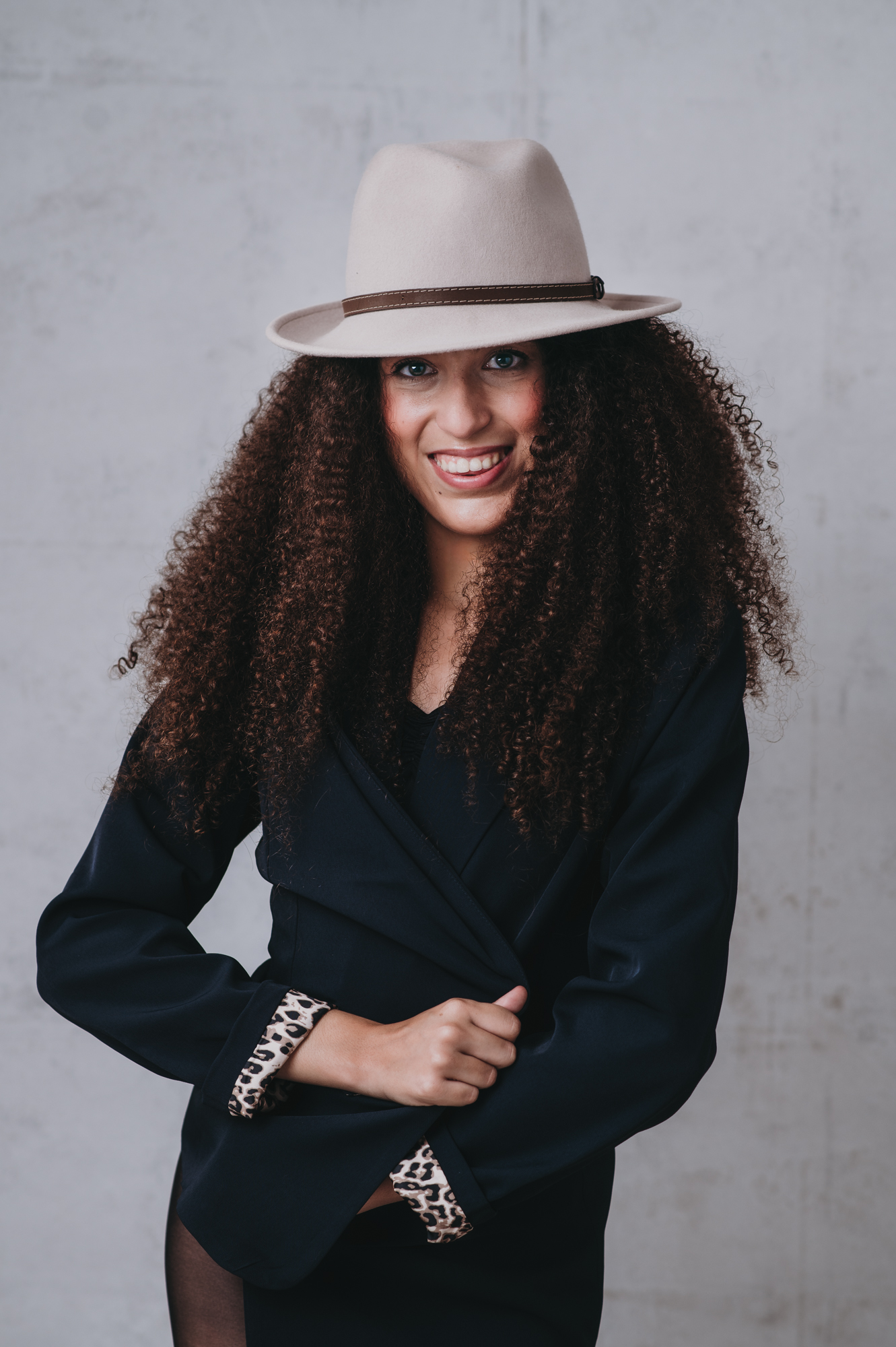 high school girl with curly hair and a hat