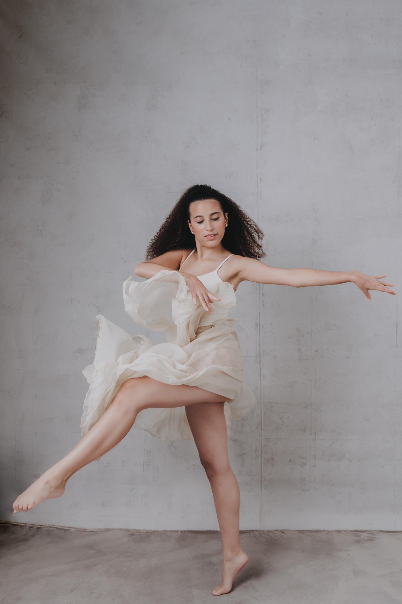 a dance passion high school senior girl portrait on a gray background at Sarasota studio