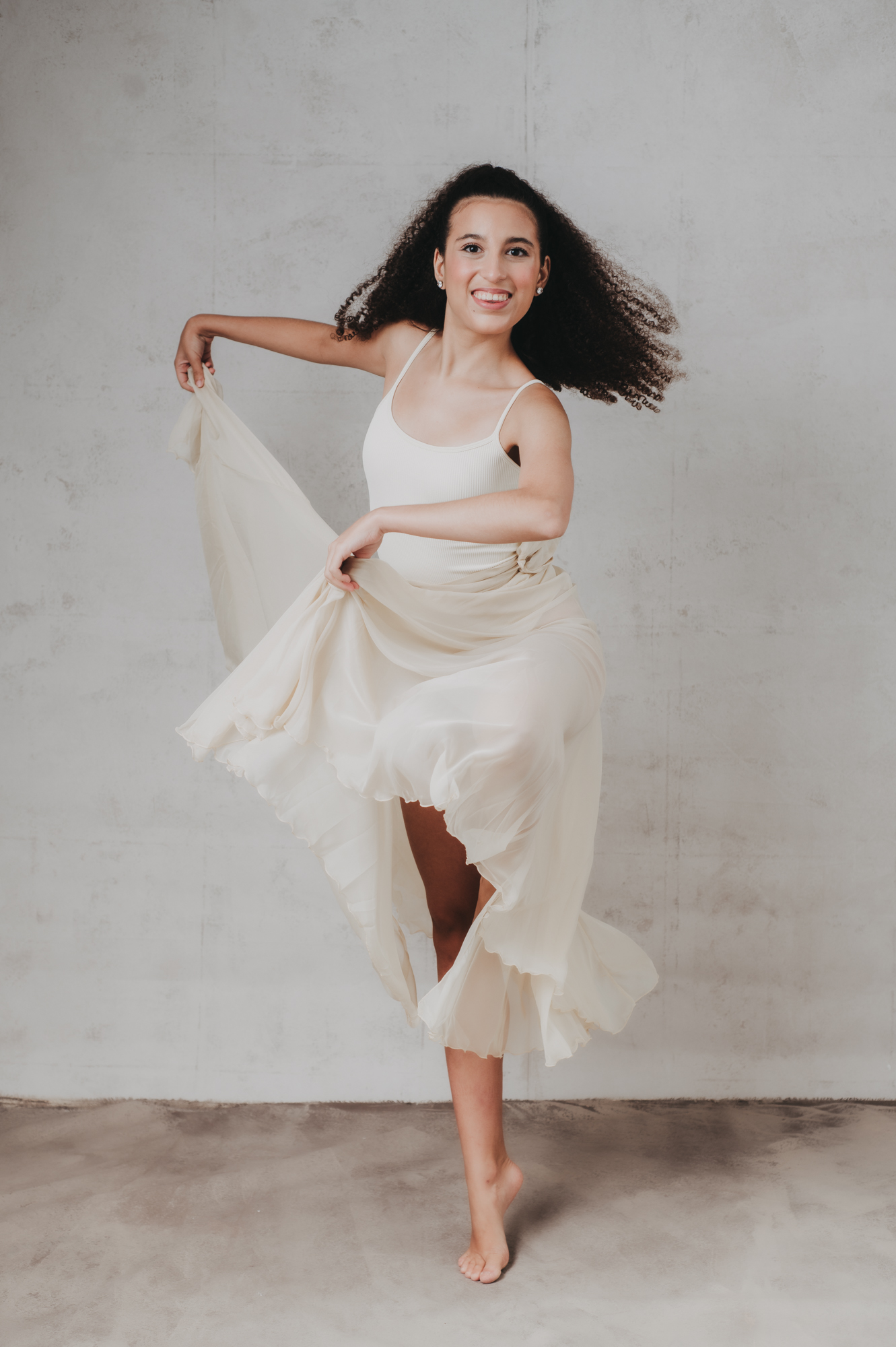 a dance passion high school senior girl portrait on a gray background at Sarasota studio