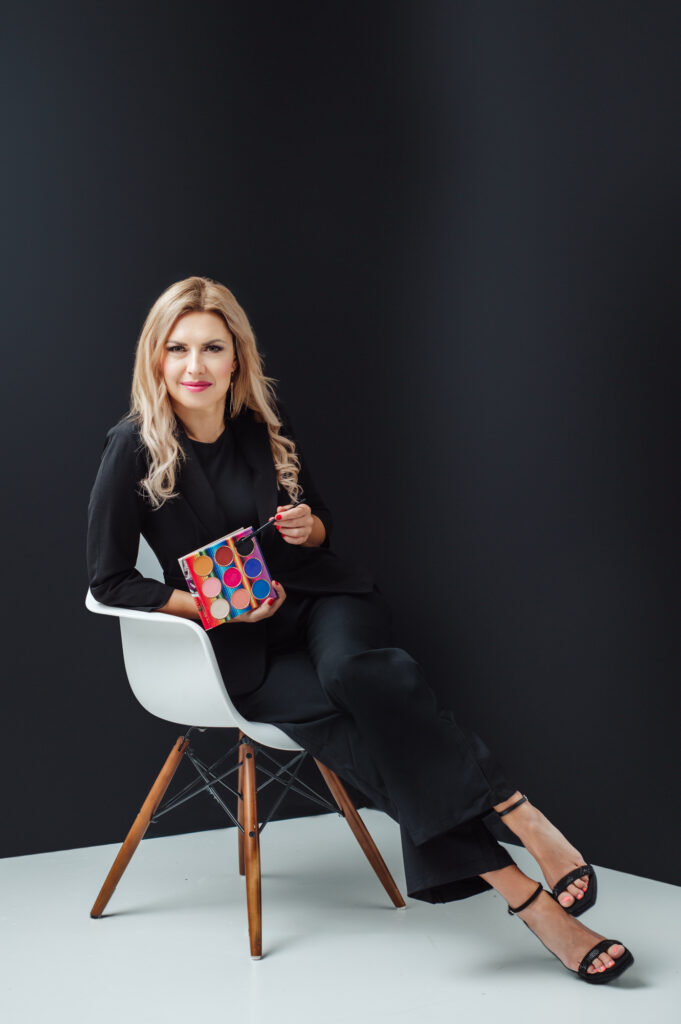 A Sarasota woman sitting in a chair holding a box of chocolates.