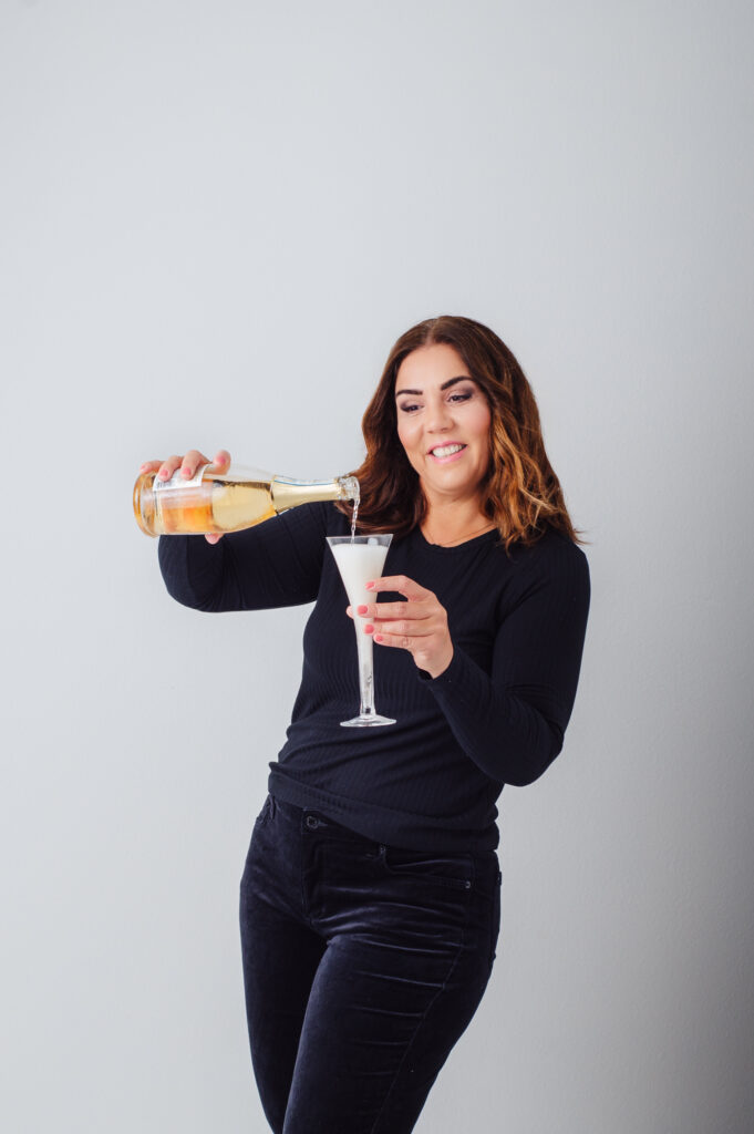 Sarasota personal branding photography captured a woman elegantly holding a glass of champagne.