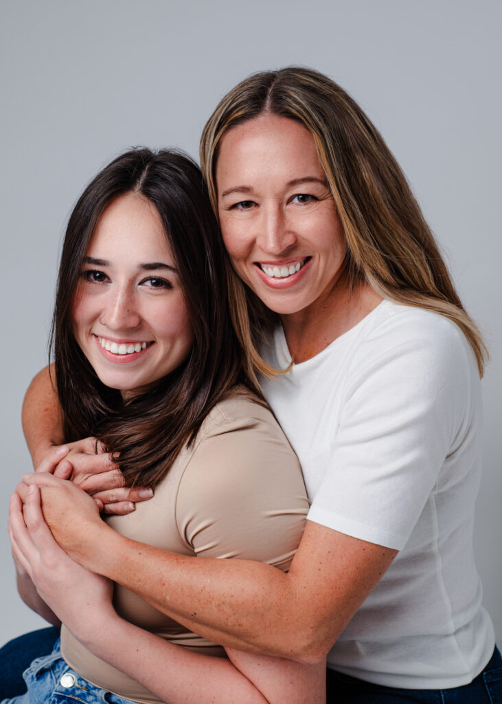 Portrait of Mom & Daughter looking into camera in studio photoshoot