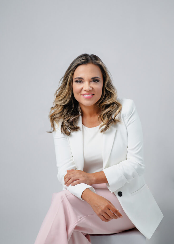 Modern Style headshot of sitting women in white blazer and pink pants