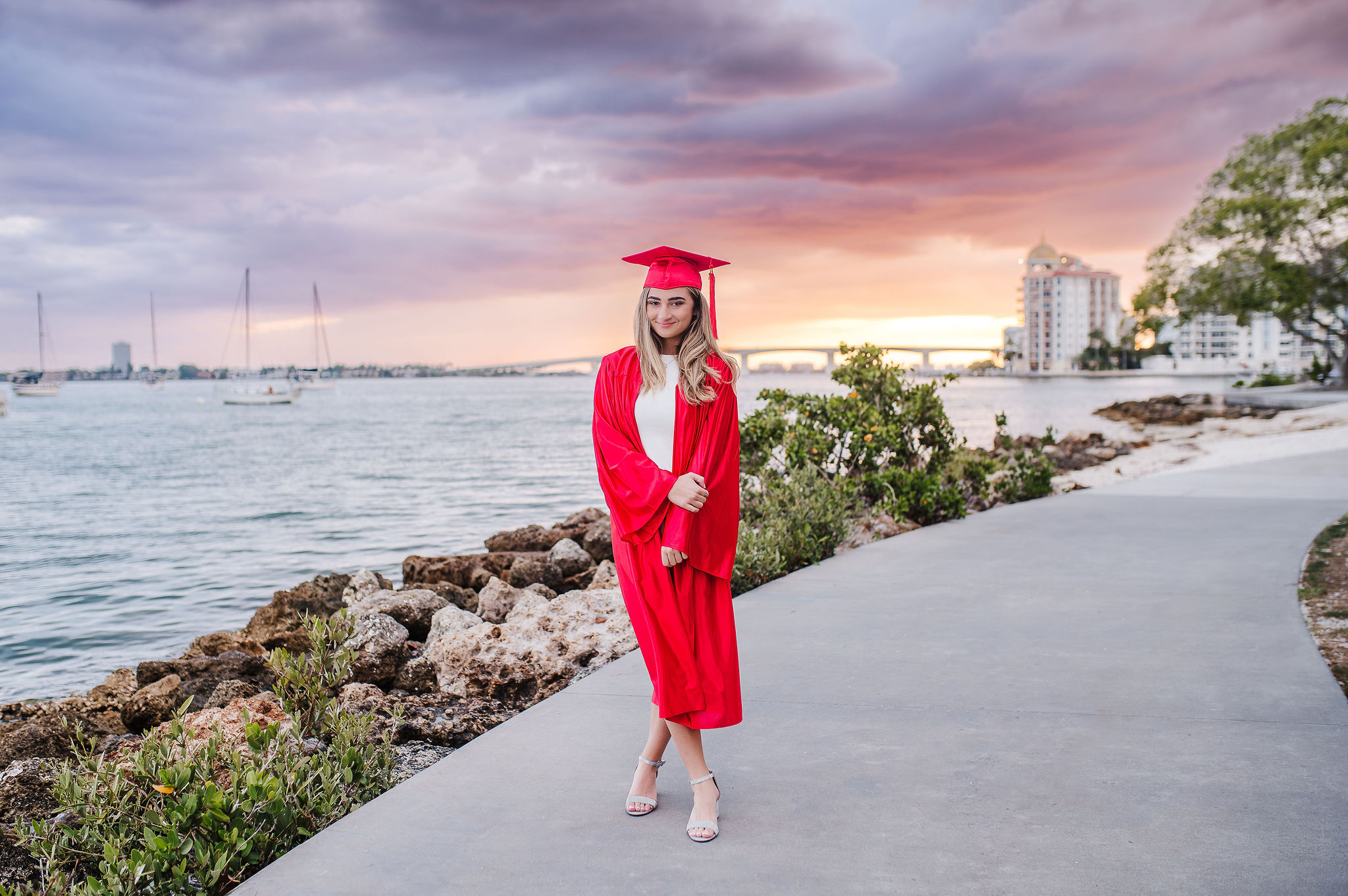 High School Senior girl in her cup posing at Marina Jack Sarasota during sunset