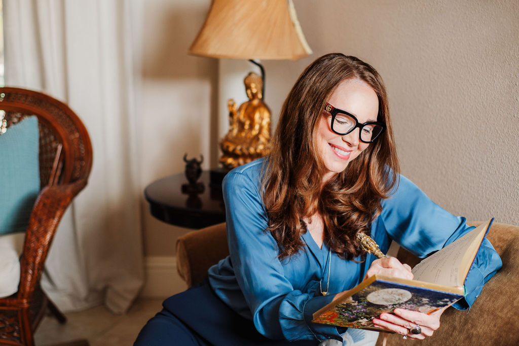 brand image of therapist siting on the sofa in her office writing in her notebook 