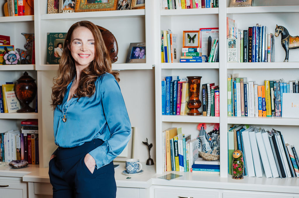 A lifestyle portrait of life coach in fer office wearing blue shirt for her brand photoshoot