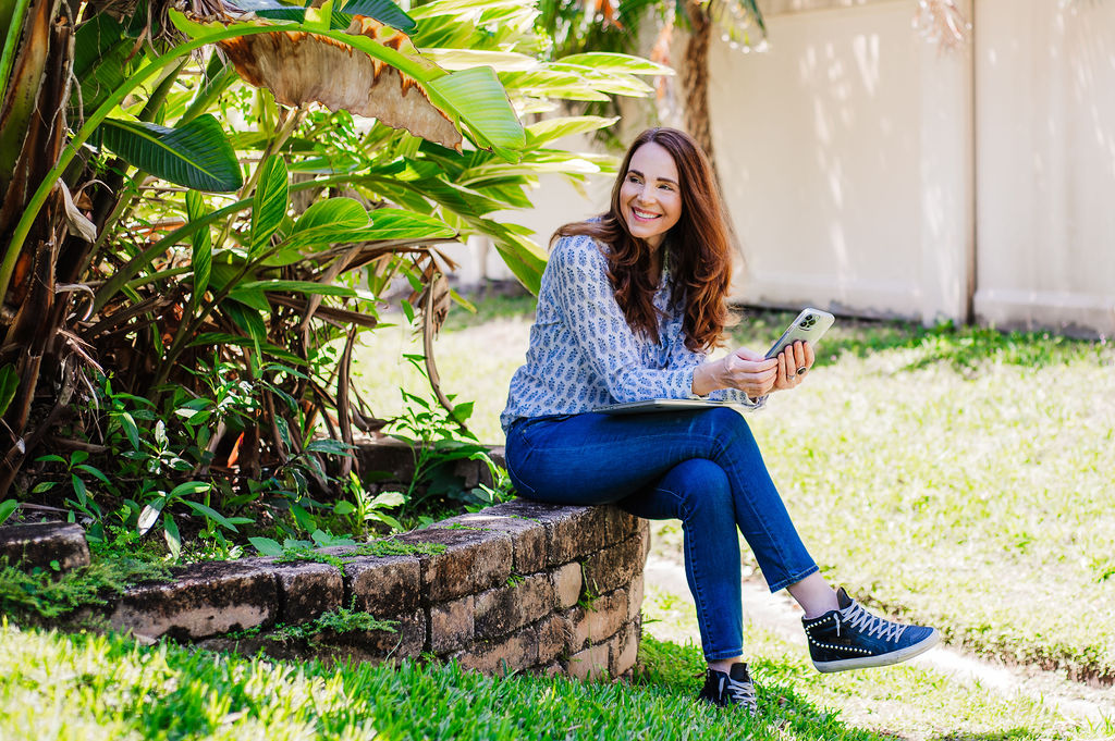 lifestyle personal branding image of women in jeans and tennis shoos checking her phone