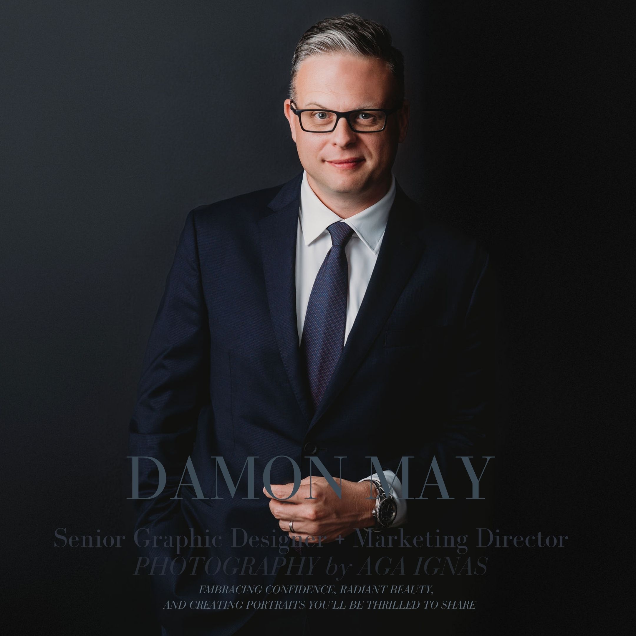 Power full portrait of men in dark suite and black glasses against dark background 