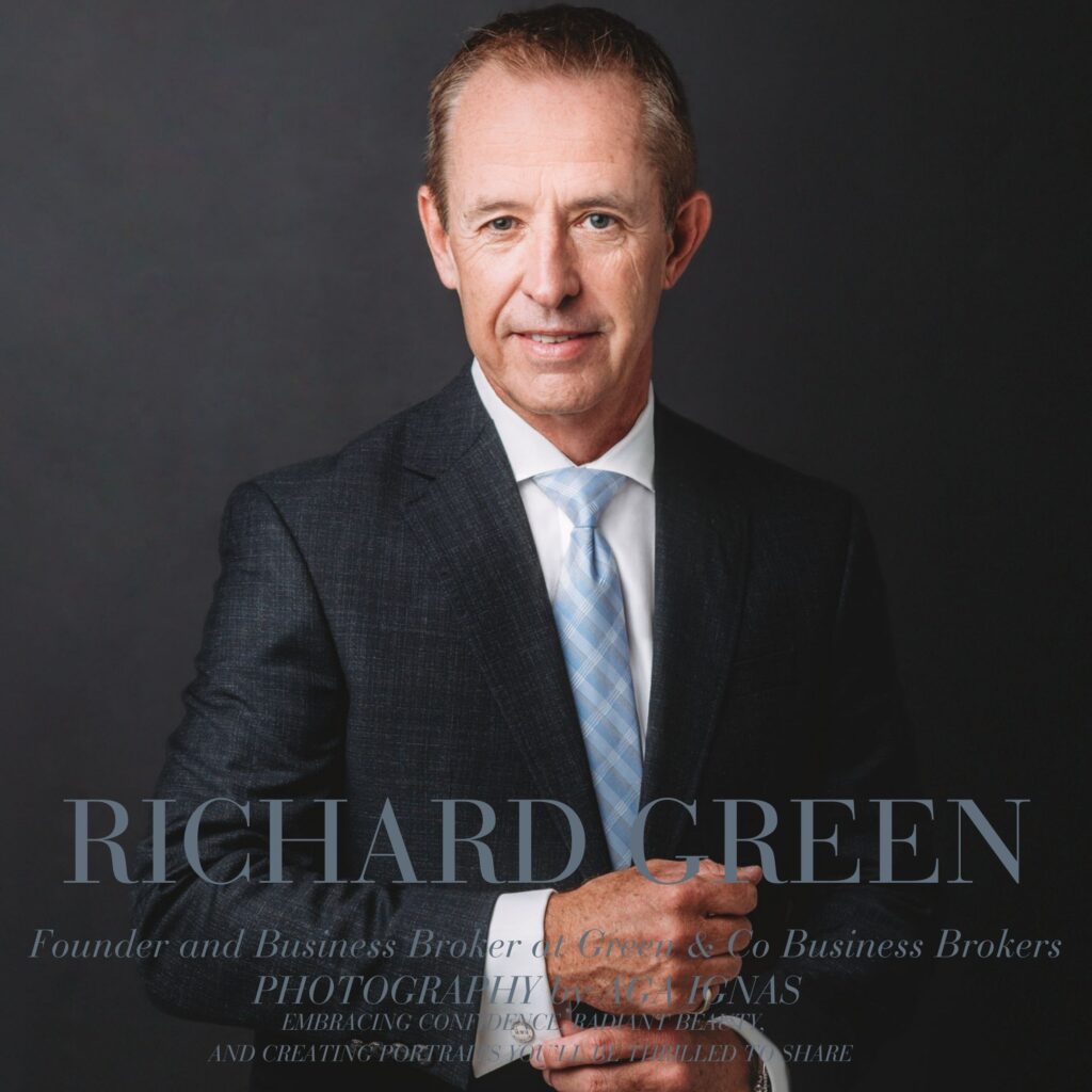 Power full portrait of men in dark suite against dark background adjusting his shirt shirt