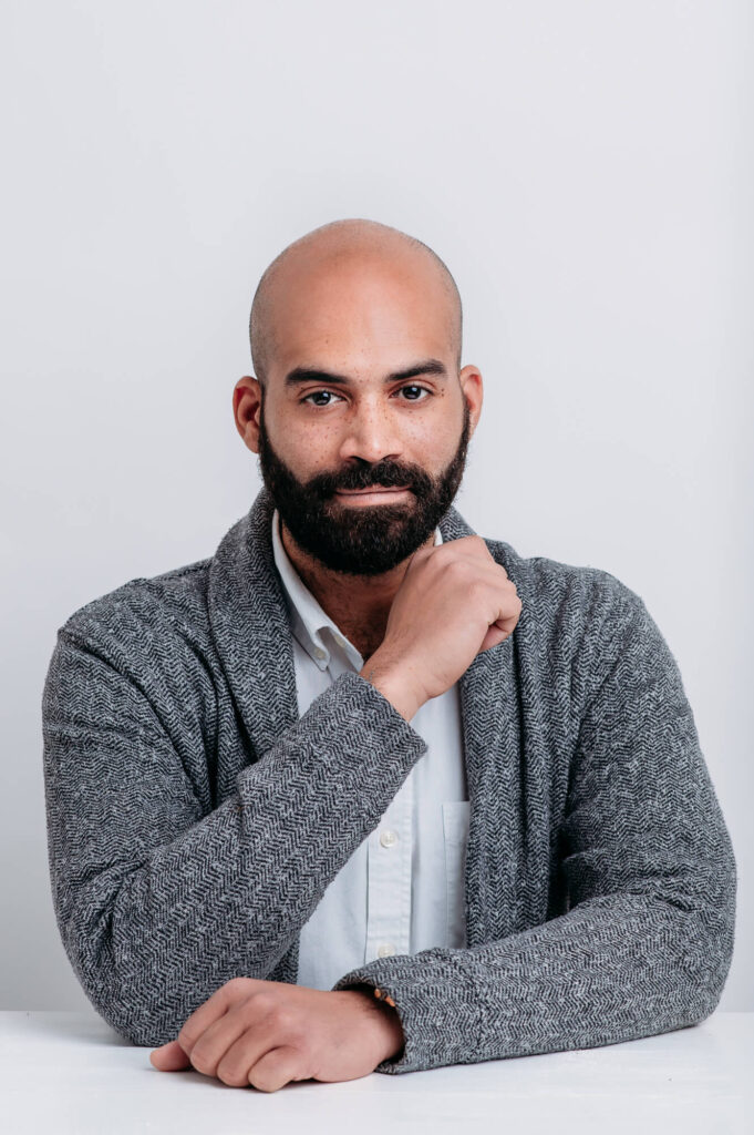 Commercial Headshot of men wearing white shirt and grey sweter